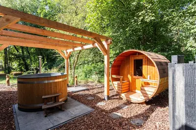 a small wooden sauna with a wooden gazebo at Résidence Lage Vuursche in Lage-Vuursche