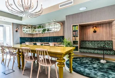 a dining room with a table and chairs and a couch at blooming in Bergen