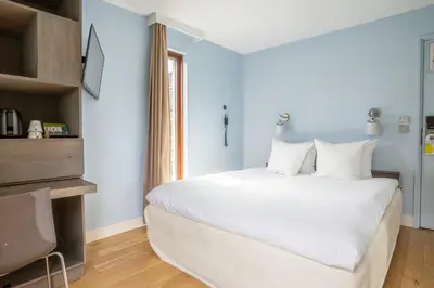 a bedroom with a large white bed and a window at blooming in Bergen