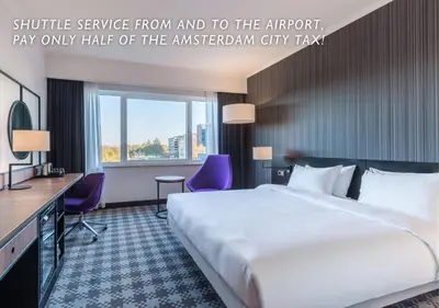 a hotel room with a large bed and a desk at Radisson Blu Hotel Amsterdam Airport, Schiphol in Schiphol