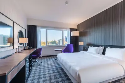 a hotel room with a large bed and a desk at Radisson Blu Hotel Amsterdam Airport, Schiphol in Schiphol