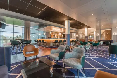 a waiting room with chairs and a bar at Radisson Blu Hotel Amsterdam Airport, Schiphol in Schiphol