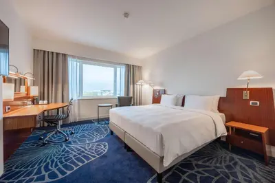 a hotel room with a large bed and a desk at Radisson Blu Hotel Amsterdam Airport, Schiphol in Schiphol