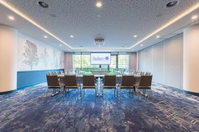 a conference room with a long table and chairs at Radisson Blu Hotel Amsterdam Airport, Schiphol in Schiphol