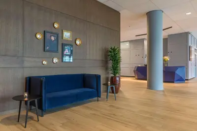 a lobby with a blue couch and a pillar at Radisson Blu Hotel Amsterdam Airport, Schiphol in Schiphol