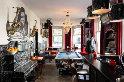a bar with a pool table in a room at Backstage Hotel Amsterdam in Amsterdam