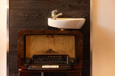 a bathroom with an old television and a sink at Backstage Hotel Amsterdam in Amsterdam