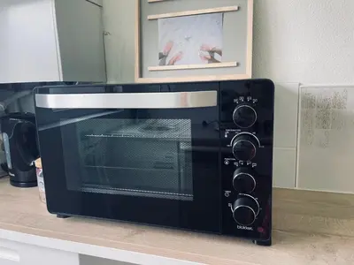 a microwave sitting on a counter in a kitchen at Tiny beachhouse - free parking in Noordwijk