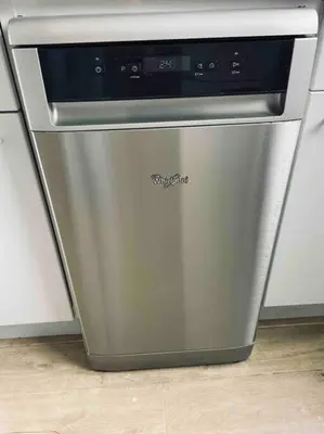 a stainless steel dishwasher in a kitchen at Tiny beachhouse - free parking in Noordwijk