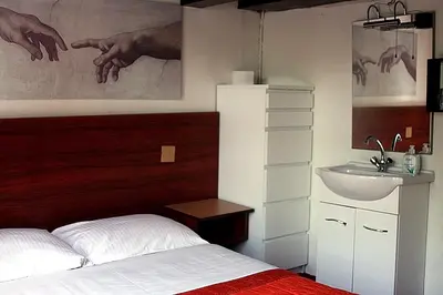 a bedroom with a bed and a sink at Hostel The Veteran in Amsterdam