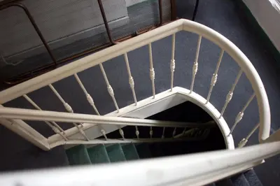 a spiral stair case in a building at Hostel The Veteran in Amsterdam