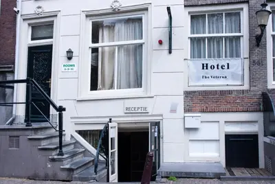 a white building with a hotel sign on it at Hostel The Veteran in Amsterdam