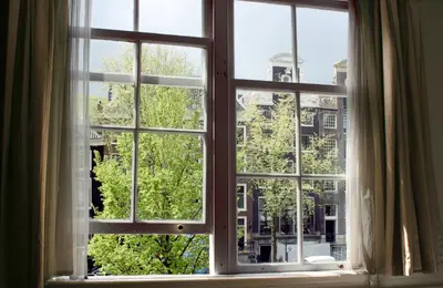 an open window with a view of a city at Hostel The Veteran in Amsterdam