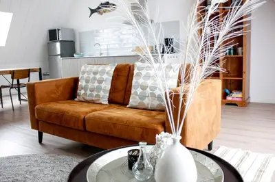 a living room with a couch and a table at Bodhi Beach House in Egmond aan Zee