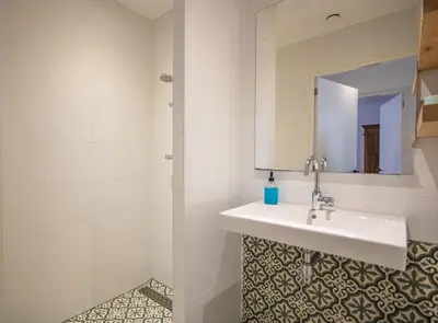 a bathroom with a sink and a mirror at Bodhi Beach House in Egmond aan Zee