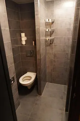 a small bathroom with a toilet in a stall at Onefam Amstel in Amsterdam