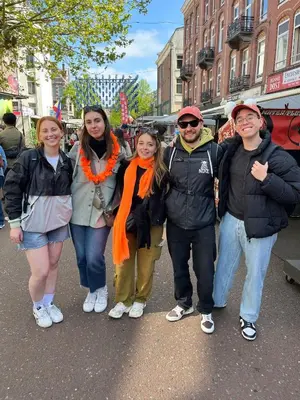 a group of people posing for a picture on a street at Onefam Amstel in Amsterdam