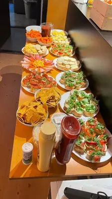 a table with many plates of food and drinks at Onefam Amstel in Amsterdam