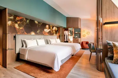 a hotel room with a large bed and a desk at Renaissance Amsterdam Hotel in Amsterdam