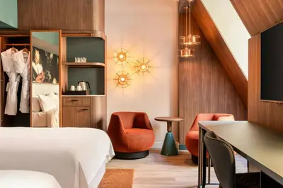 a hotel room with a bed and two chairs at Renaissance Amsterdam Hotel in Amsterdam