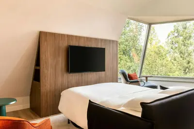 a bedroom with a bed and a tv on a wall at Renaissance Amsterdam Hotel in Amsterdam