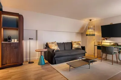 a living room with a couch and a table at Renaissance Amsterdam Hotel in Amsterdam