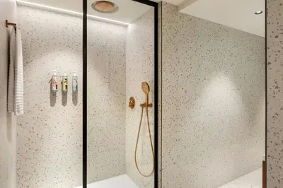a shower in a bathroom with a glass door at Renaissance Amsterdam Hotel in Amsterdam