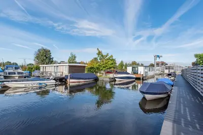 a group of boats are docked in a marina at Beautiful Water Villa, near Schiphol and Amsterdam in Aalsmeer