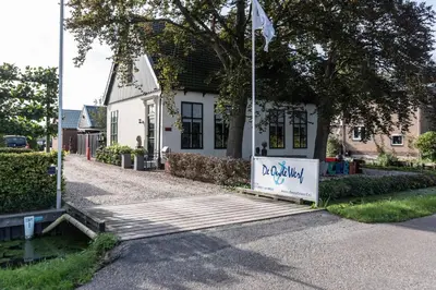 a house with a sign that says paddley in front of it at Beautiful Water Villa, near Schiphol and Amsterdam in Aalsmeer