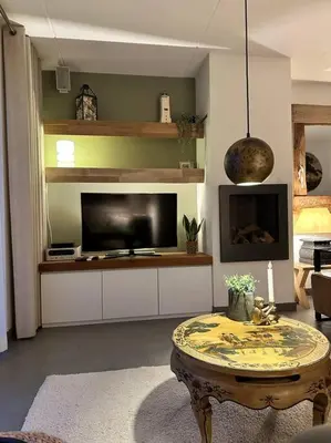 a living room with a tv and a coffee table at Have a nice stay! - Beachhouse Zonneweelde in Noordwijk