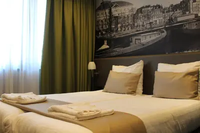 a hotel room with a bed with towels on it at Royal Amsterdam Hotel in Amsterdam