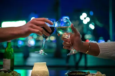 two people are holding glasses of wine at Royal Amsterdam Hotel in Amsterdam
