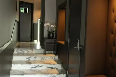a hallway with a marble staircase with a door at Royal Amsterdam Hotel in Amsterdam