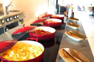 a row of bowls of food on a counter in a kitchen at HOTEL ALKMAAR - Bar & Restaurant - Meeting & Events in Alkmaar