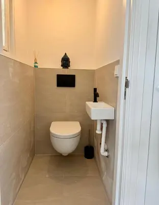 a small bathroom with a toilet and a sink at @92 in Zandvoort