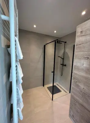 a bathroom with a shower with a glass door at @92 in Zandvoort