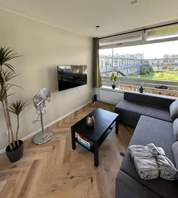 a living room with a couch and a table at @92 in Zandvoort