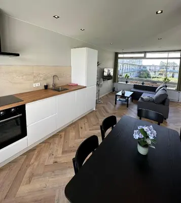a kitchen and living room with a table and chairs at @92 in Zandvoort