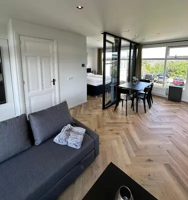 a living room with a couch and a table at @92 in Zandvoort
