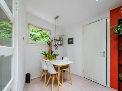 a dining room with a white table and white chairs at Holiday house in Bergen with sauna in Bergen