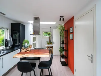 a kitchen and dining room with a wooden table and chairs at Holiday house in Bergen with sauna in Bergen