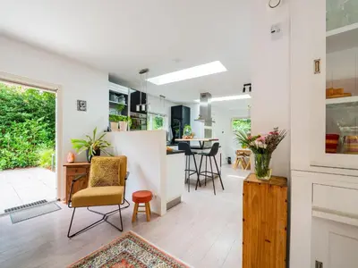 a kitchen and living room with a table and chairs at Holiday house in Bergen with sauna in Bergen