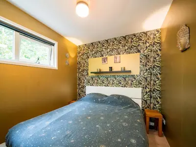 a bedroom with a blue bed in the corner at Holiday house in Bergen with sauna in Bergen