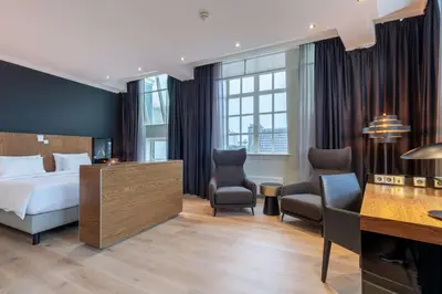 a hotel room with a bed and a desk at Radisson Blu Hotel, Amsterdam City Center in Amsterdam