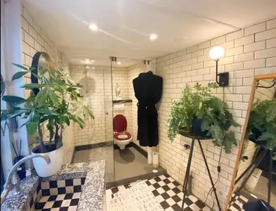 a bathroom with a toilet and plants on the wall at The smallest hotel in Amsterdam in Amsterdam
