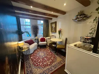 a living room with a couch and a table at The smallest hotel in Amsterdam in Amsterdam
