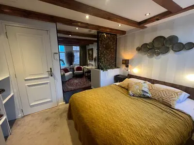 a bedroom with a bed and a living room at The smallest hotel in Amsterdam in Amsterdam