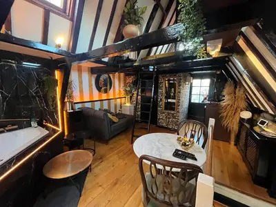 a living room with a table and a bath tub at The smallest hotel in Amsterdam in Amsterdam