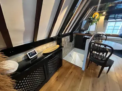 a room with a desk and a table and a chair at The smallest hotel in Amsterdam in Amsterdam