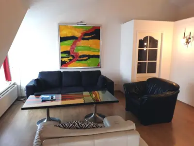 a living room with a couch and a coffee table at Fletcher Hotel Restaurant Marijke in Bergen